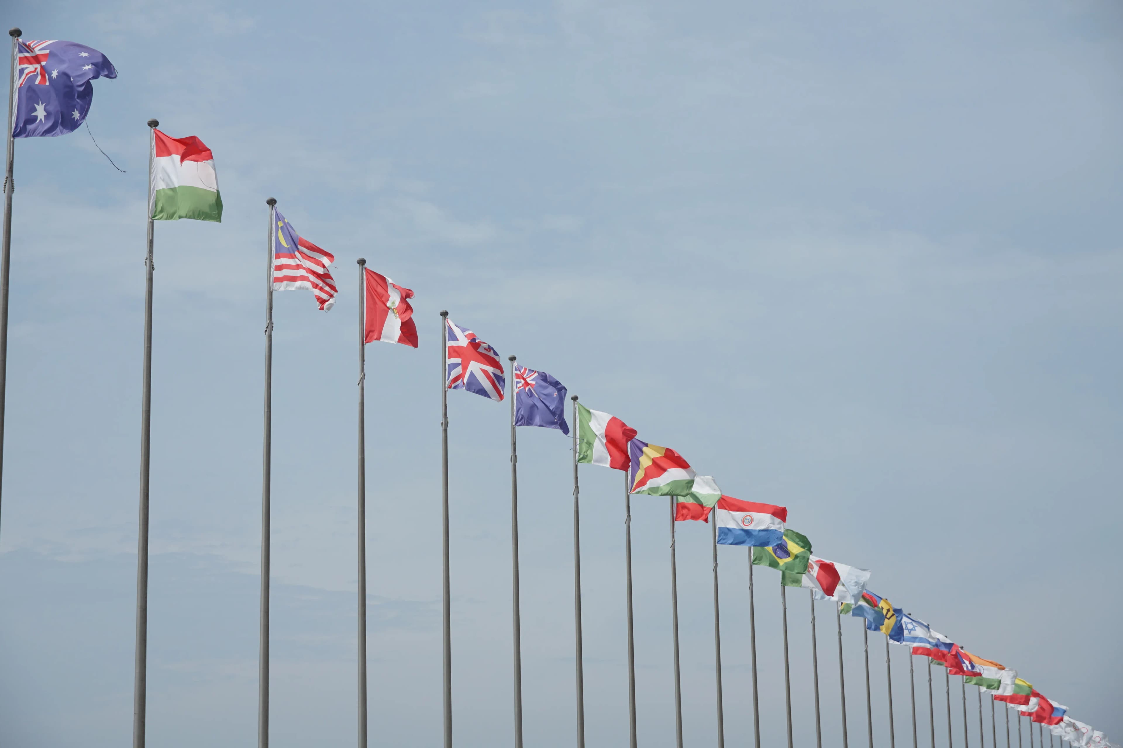 International flags representing migration, borders, and global communities