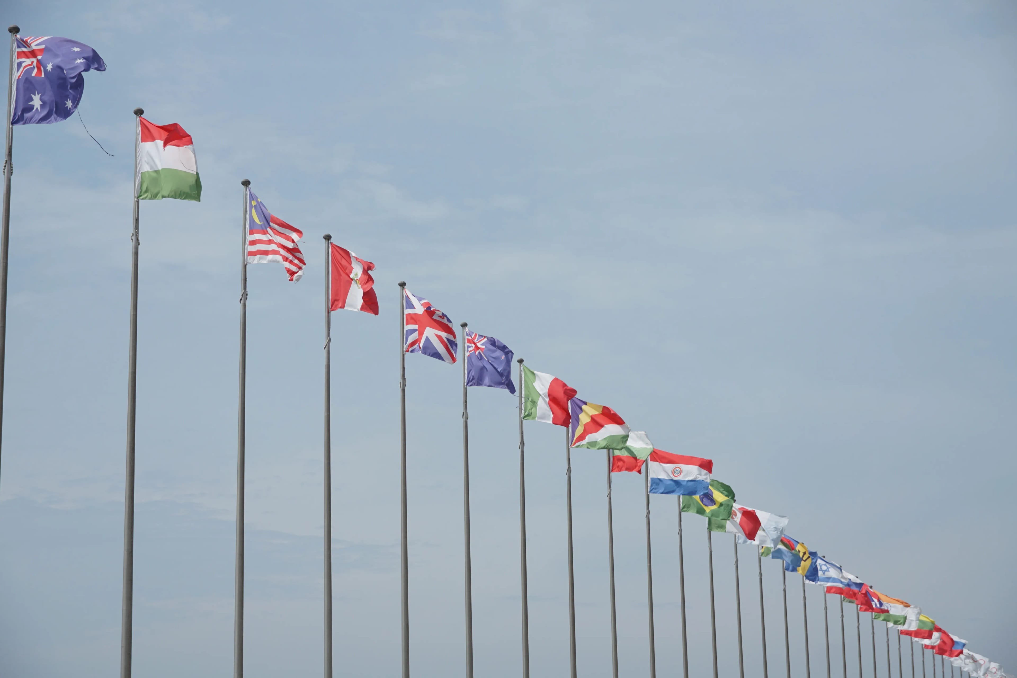 International flags representing migration, borders, and global communities