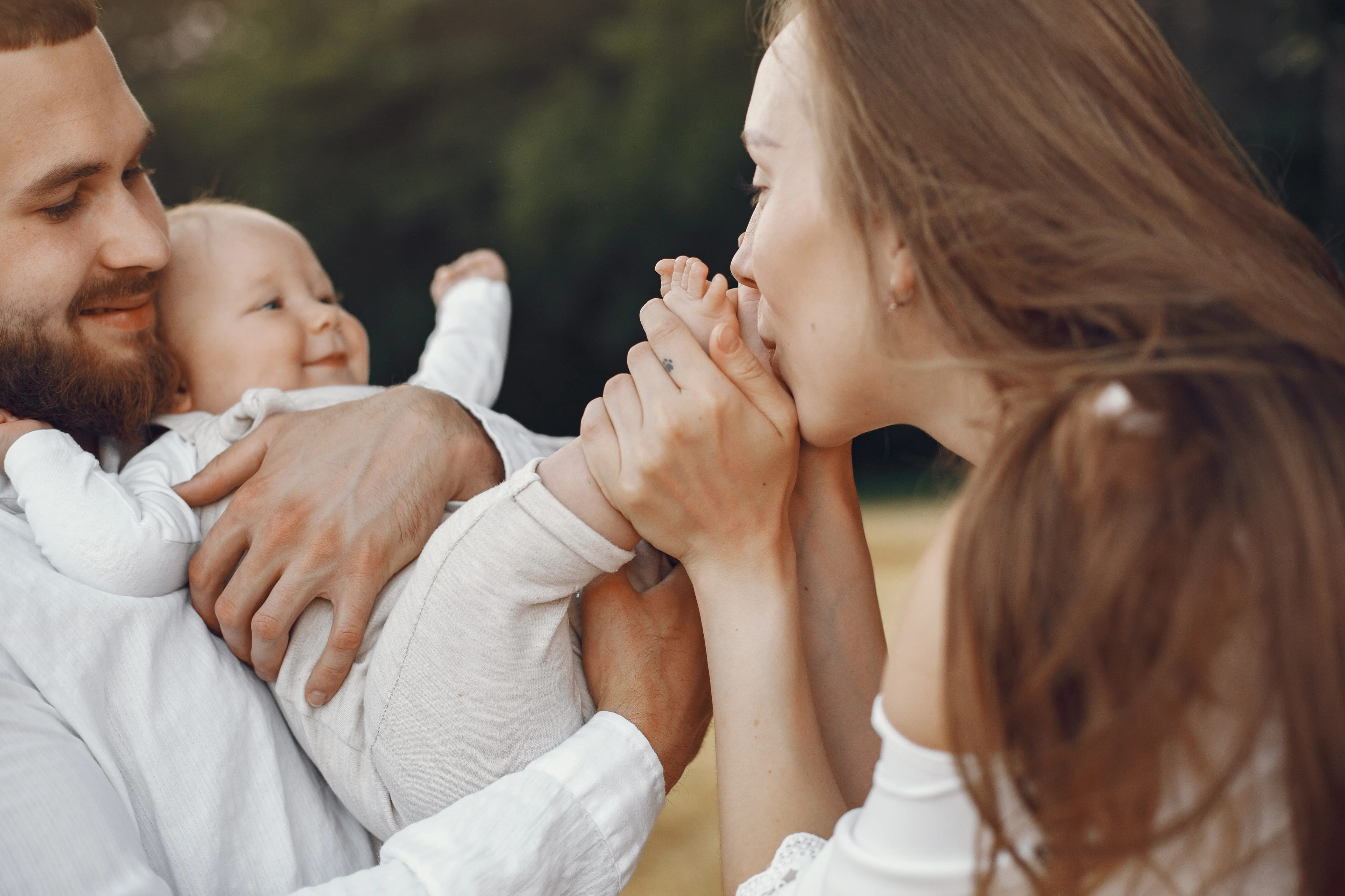 Parents spending a joyful moment with their baby outdoors